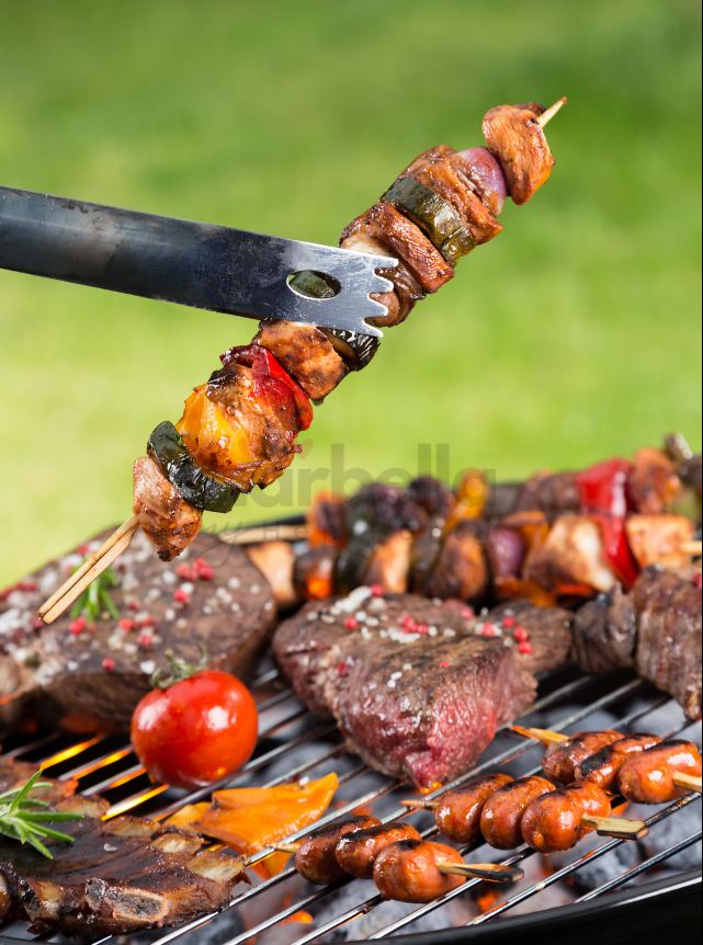 Skewers and meats on the grill at a Marbella villa BBQ